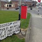 A sign erected on Patrick Street in response to the potholes on the road surface, allegedly due to the high volume of heavy trucks using the route.