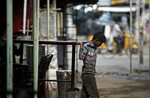 Indian children, working at a roadside hotel, carry a table in Hyderabad, India, Wednesday, Aug. 29, 2012.