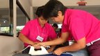 Student being taught to iron