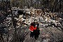 Amy Hubbard with her Mum, Catherine and the ruins of their home in Buena Vista Rd Winmalee that was destroyed from yesterday's fires in the Blue Mountains.