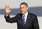 President Barack Obama waves to supporters after descending the steps on Air Force One after arriving in Orlando, Fla., Tuesday, Oct. 11, 2011. (AP Photo/Reinhold Matay)