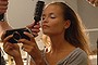 NEW YORK - SEPTEMBER 13:  A model has her hair done while playing a portable video game backstage at the Narciso Rodriguez Spring 2006 fashion show during Olympus Fashion Week at Exit Art September 13, 2005 in New York City.  (Photo by Brad Barket/Getty Images)