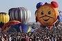 Hot air balloons, one of them shaped like a clock, are prepared before taking flight during the 42nd annual Albuquerque International Balloon Fiesta in Albuquerque, New Mexico October 5, 2013. Thousands of spectators gathered on Saturday at the city's balloon park to watch more than 500 balloons of all shapes and sizes lift off in two stages during the so-called mass ascensions.