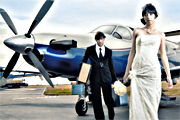 Generic istock photo of a wedding couple and an airplane.