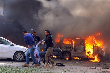 In this photo provided by the Syrian official news agency SANA, Syrian security agents carry a body following a huge explosion that shook central Damascus, Syria, Thursday, Feb. 21, 2013.