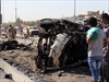 Iraqis inspect the site of a car bomb explosion in Baghdad.