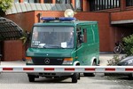 A van transports two Somali prisoners towards prison, outside court in Bruges, Belgium, Tuesday, Oct. 15, 2013. Belgian authorities say they have arrested a kingpin of modern-day piracy by luring him from Somalia on the promise of participating in a movie project on such high seas crime. Instead of signing a contract as an expert adviser in the documentary project, Mohamed Abdi Hassan, also known as Afwayne, was arrested at Brussels international airport over the weekend and immediately put behind bars.