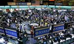 Crude oil traders work in the half empty pit on the floor of the New York Mercantile Exchange, in this Feb. 21, 2008 file photo. The parent company of the Chicago Mercantile Exchange and the Chicago Board of Trade on Monday, March 17, 2008 said that it would buy the owner of the New York Mercantile Exchange in a cash-and-stock deal valued at almost $9.5 billion.