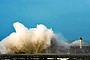 Large waves break against the dyke at the entrance of the port of Boulogne, northern France.