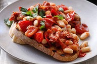 White beans with spicy chipotle tomatoes on toast.