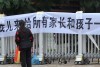 Protest sign after suicide of 10yo boy in China