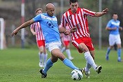 Belconnen United player Elliot Zwangobani challenges Canberra Olympic player Mark Shields for the ball.