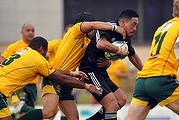 New Zealand player, Eli Elisara, is tackled by Apensia Matairavula and Tuan Chiem.