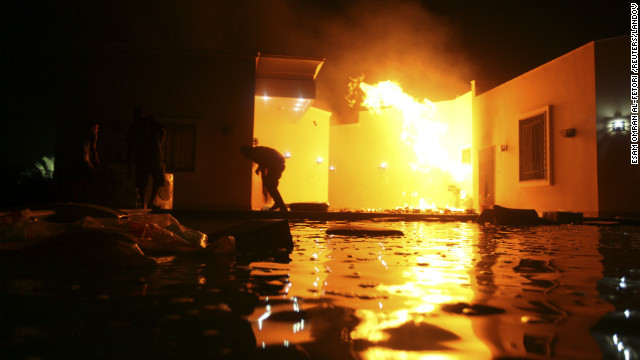 People duck flames outside a consulate building on September 11.