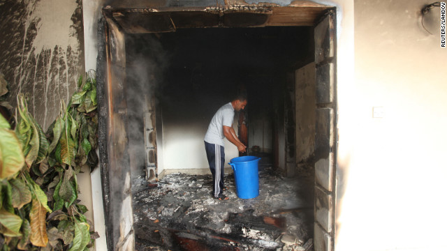 A man stands in part of the burned-out compound on September 12. 