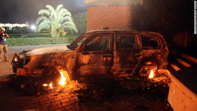 A vehicle sits smoldering in flames on September 11.