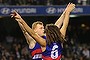 V for victory: Adam Cooney celebrates the win over Carlton. 