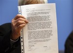 Opposition Greens lawmaker Hans-Christian Stroebele, shows a letter he received from Edward Snowden to the media prior to a press conference in Berlin, Germany, Friday, Nov. 1, 2013.