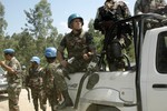 A convoy of the UN Organization Stabilization Mission in the Democratic Republic of the Congo (MONUSCO) waits for the road to clear while on patrol in Rutshuru Territory, North Kivu, near the Democratic Republic of the Congo’s border with Uganda, 31 October, 2013.