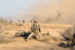 File - Sgt. Kevin Fischer, Sight Security Team 1st Battalion 161st Field Artillery, signals his security team to fill in the security perimeter, August 22, 2011, in the deserts of Djibouti.