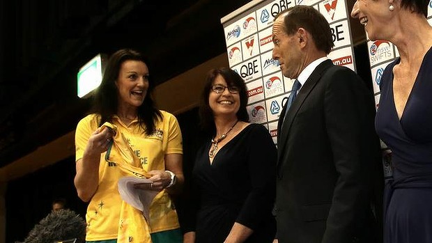 Opposition Leader Tony Abbott is presented with a netball bodysuit by netball player Bianca Chatfield  during his visit to Sydney Olympic Park on Thursday.