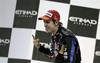 Red Bull driver Sebastian Vettel of Germany celebrates on the podium after becoming Formula One World Champion 2010 at the Emirates Formula One Grand Prix at the Yas Marina racetrack in Abu Dhabi, United Arab Emirates, Sunday, Nov. 14, 2010.