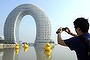 A man takes pictures of the Sheraton Huzhou Hot Spring Resort, or 