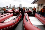 Philippine Coast Guard Chief Rear Adm. Rodolfo Isorena checks newly-acquired rubber boats following blessing ceremony Wednesday, Nov. 6, 2013 in Manila, Philippines.