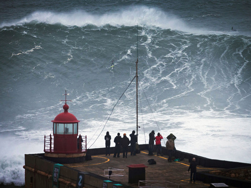 This surfer may be headed to the record books by surfing an estimated 100 ft. wave