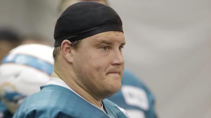 In this May 29, 2013 file photo, Miami Dolphins guard Richie Incognito watches during an NFL football practice at the Dolphins training facility in Davie, Fla. Suspended Dolphins guard Incognito sent text messages to teammate Jonathan Martin that were racist and threatening, two people familiar with the situation said Monday, Nov. 4, 2013. The people spoke to The Associated Press on condition of anonymity because the Dolphins and NFL haven't disclosed the nature of the misconduct that led to Incognito's suspension. (AP Photo/Wilfredo Lee, File)