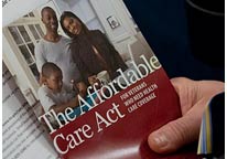 Image: An audience member holds a pamphlet about the federal health care law at an informational town hall meeting in Pottsville, Pa., earlier this month (© Matt Rourke/AP) 