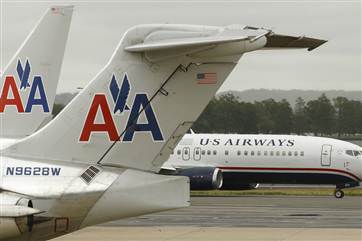 Shares in US Airways were halted Tuesday, amid reports that the airline and its prospective merger partner AMR were close to settling a state and fede...