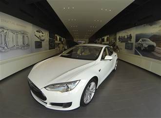 A Tesla Model S electric car is on display at a Tesla store in a shopping mall in La Jolla, Calif., on Sept. 6. 