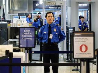 A Transportation Security Administration agent waits for passengers to use the TSA PreCheck lane at Miami International Airport on October 4, 2011, in Miami. The program now is available at 97 airports across the country.