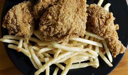 Doughnuts from Dunkin" Donuts, French fries from McDonald's and fried chicken from Kentucky Fried Chicken are displayed 27 September 2006 in Miami, Fl...