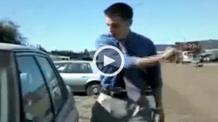 Image: Video still of a reporter trying to break a car window (Courtesy of StupidVideos)