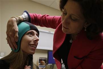 In this Wednesday, July 10, 2013, photo, Dr. Hope Rugo, right, an oncologist and breast cancer specialist, demonstrates the use of the Dignitana Digni...