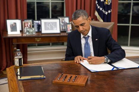 President Barack Obama signs H.R. 3210, Pay Our Military Act, which provides continuing appropriations for pay and allowances for members of the Armed Forces during any period for which interim or full-year appropriations for FY 2014 are not in effect, in the Oval Office, Monday night, Sept. 30, 2013.