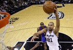 San Antonio Spurs' Tim Duncan (21) leaps to the basket past New York Knicks' Toney Douglas (23) and Amare Stoudemire, center, for a dunk during the fourth quarter of an NBA basketball game, Friday, Jan. 21, 2011 in San Antonio. San Antonio won 101-92.(AP Photo/Eric Gay)