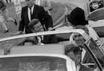 File - President John F. Kennedy, first lady Jacqueline Kennedy and Texas Gov. John Connally are shown as their limousine heads for Air Force One at Brooks Air Force Base in San Antonio, Nov. 21, 1963.