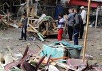 Iraqis inspect the aftermath of a late-night bombing at a cafe in Bayaa neighborhood, southwestern Baghdad, Iraq, Thursday, Nov. 21, 2013.