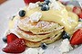 Sweet start: Fluffy hotcakes with passionfruit curd and fruit.