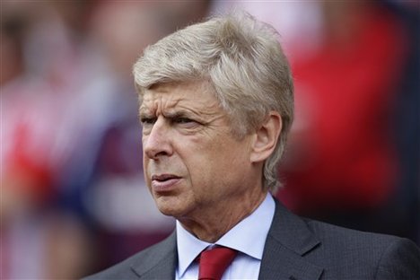 Arsenal's manager Arsene Wenger takes to the touchline before his team's English Premier League soccer match against Stoke at Britannia Stadium, Stoke, England, Sunday, Aug. 26, 2012.