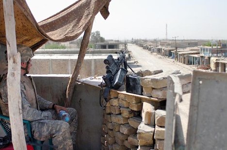 File - A Paratrooper from the 82nd Airborne Division keeps a lookout over a main avenue of approach in the Sangin city district center of Helmand Province, Afghanistan, April 14, 2007.