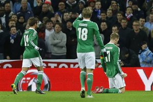 Germany's Per Mertesacker, right, celebrates his goal against England during the international friendly soccer match between England and Germany, at Wembley Stadium in London, Tuesday, Nov. 19, 2013.