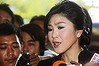 Yingluck Shinawatra, Thailand's prime minister, speaks to members of the media as she arrives at Parliament House in Bangkok, Thailand, on Thursday.