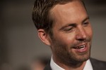 Actor Paul Walker speaks to media members as he arrives to attend the premiere of the film Fast Five in Rio de Janeiro, Brazil, Friday April 15, 2011.