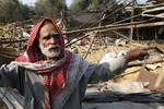 A Palestinian man - the owner of a poultry farm - expresses his anger in front of the cameras of journalists after the farm was targeted in an overnight Israeli air strike in Khan Yunis in the southern Gaza Strip on November 20, 2013.