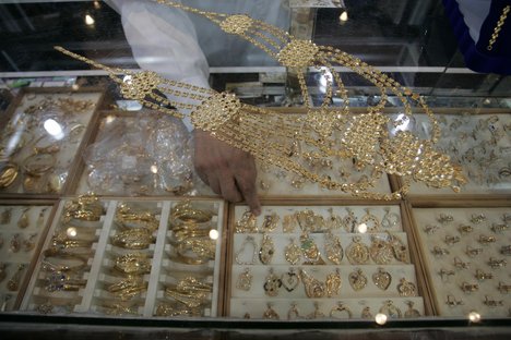 A Palestinian vendor displays a gold jewellery at a jewellery store in the Rafah Refugee Camp, Southern Gaza Strip on September. 19, 2011. Decline in demand for gold in the Palestinian markets due to the high price of $ 50 per gram, this high price in the global gold. ( Photo by Ahmed Deeb/WN)