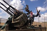 File - A 21-year-old from Denmark poses for a photo as he sits on top of a Soviet-made anti-aircraft gun in May 2013 at a training camp inside Syria near Idlib and Aleppo.